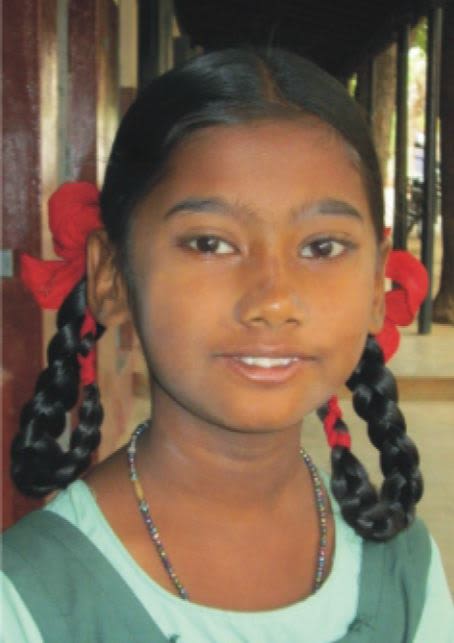 Head shot of Aathila Banu with pigtails in red ribbons