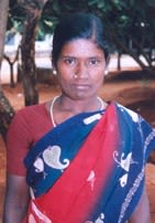 Pothumani, smiling in her blue and white dress and red sari